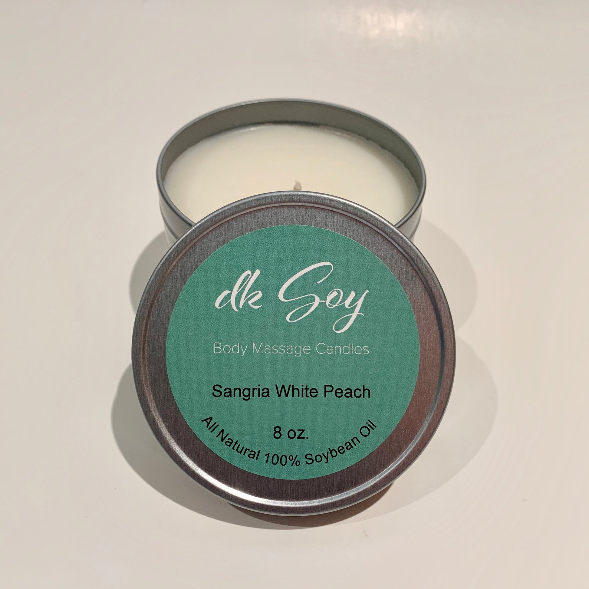 large sangria white peach travel tin massage oil candle